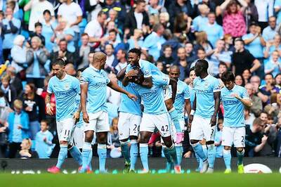Manchester City flex muscles as English clubs break spending record