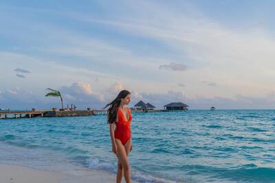 Producer Madhu Mantena's Wife Ira Trivedi Slays Beach Look In Red Monokini