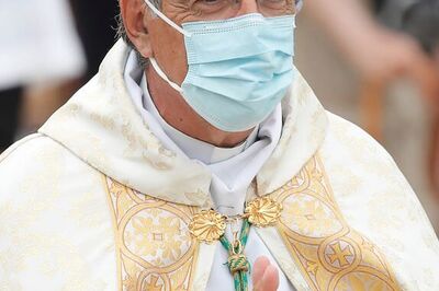 Wearing masks, French pilgrims send a message of hope ahead of religious feast