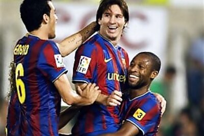 Barca back on top after 2-1 win over Malaga